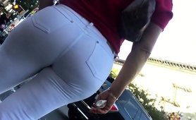 hot-babe-in-tight-white-jeans-is-followed-by-a-street-voyeur